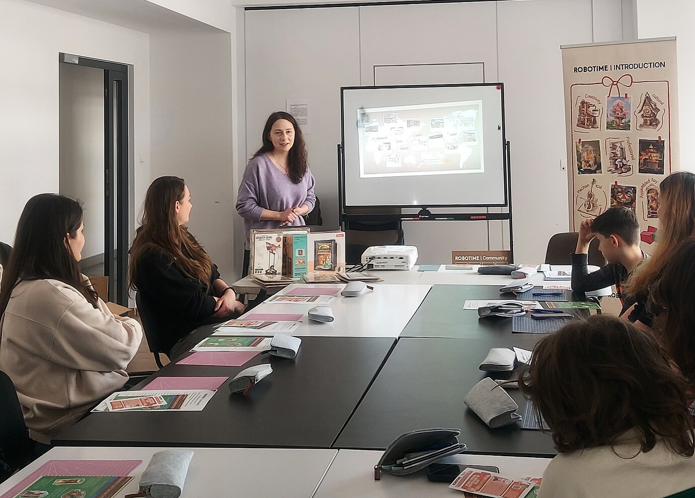Aga introduces Robotime to seated participants in the Warsaw workshop room