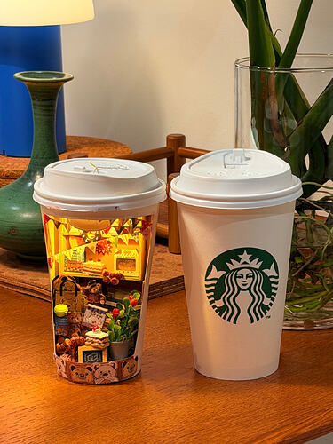 finished Starbucks cup miniature beside original cup