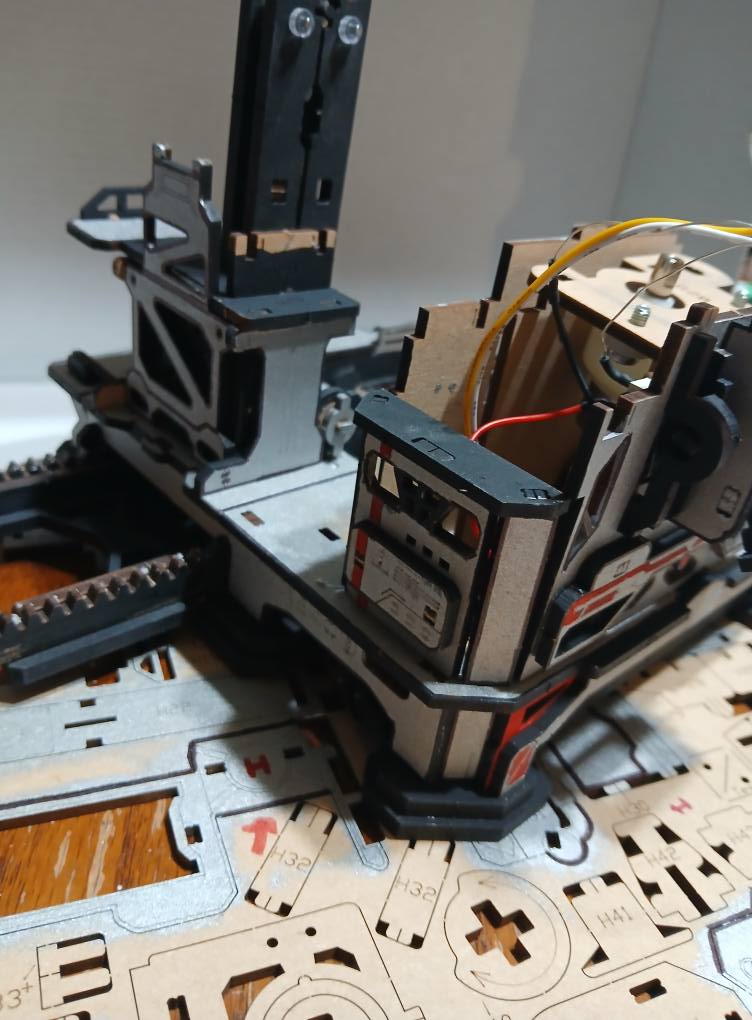 Partially assembled painted launch tower with wiring visible